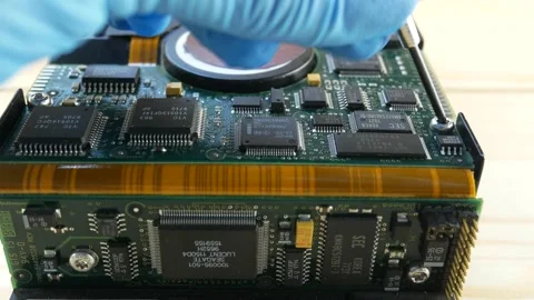 The master's hands twist the computer's system drive with a screwdriver. Stock Footage 303650613