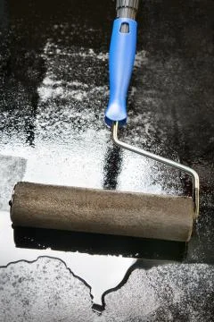 Mastic asphalt coating using a paint roller Stock Photos