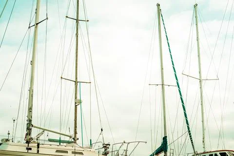 Masts and rigging of a sailing ship against blue sky. Toned. Stock Photos