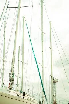 Masts and rigging of a sailing ship against blue sky. Toned. Stock Photos