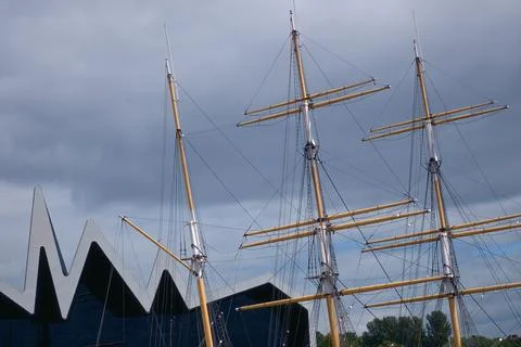 The masts of an old sailing ship moored to the pier Stock Photos