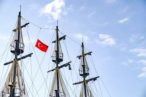 Masts of ship with Turkish flag on background of sky. Stock Photos