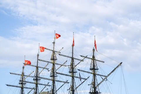 Masts of ship with turkish flags on background of sky. Stock Photos