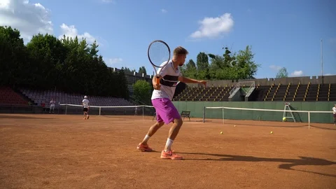 Match between two young tennis player on clay court. Steady gimbal shot. 4K. Stock-Footage 109365885