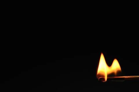 Match burning with black background Stock Photos