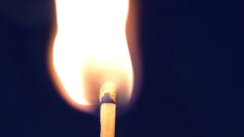 Match burning on the blue background slow motion Stock Footage 76194393