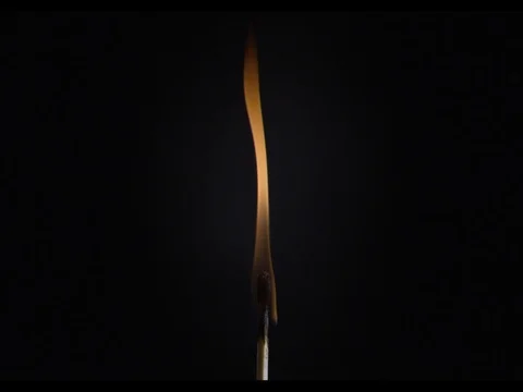 Match burning, bottom part of a macroshot, slow motion, fire burns Stock Footage