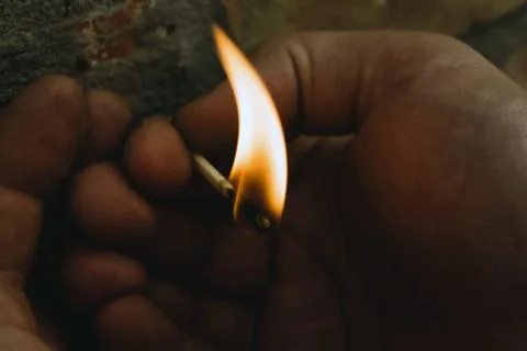 The match is burning in the hands Stock Photos