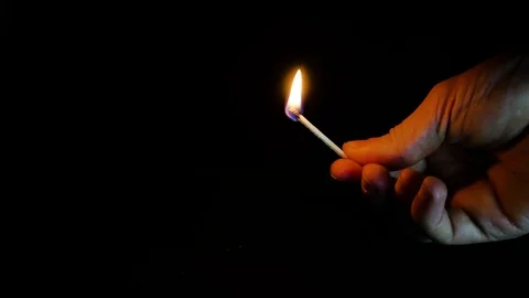 The match burns to the end on a dark background Stock Footage 101127387