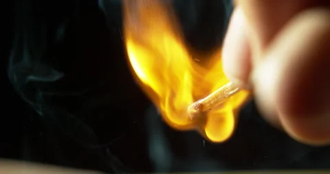 Match, hand and orange flame with strike and ignite in studio with dark Stock Footage 242115346