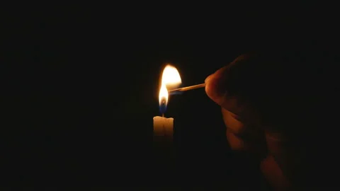 Match in hand sets fire to the candle Stock Footage 104375242