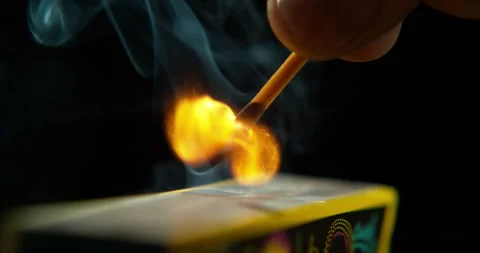 Match ignite, hand and orange flame with smoke and smoking in studio with dark Stock Footage 243318525