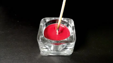 Match igniting a red candle, then the wind blow it out 스톡 동영상 131419110