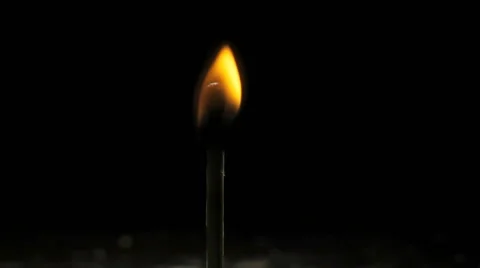 A match lights on a dark black background Vidéo 58056791