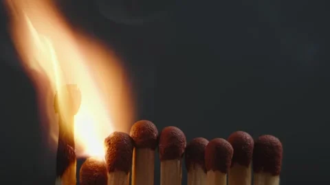 The match lights up first to light all the rows of matches behind it.  Stock Footage 283156433