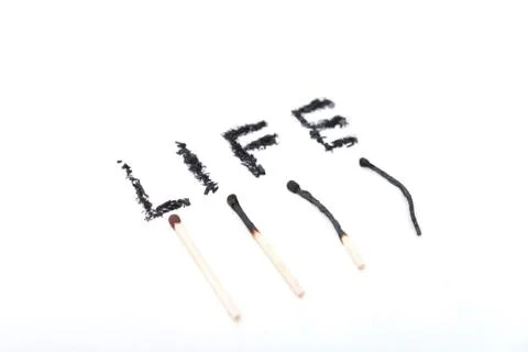 A match lying on a white background Stock Photos