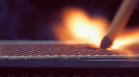 The match moves on the side of the matchbox and light the fire. Macro Video stock 61550798