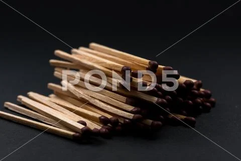 Match sticks accumulated on top of each other. Match sticks and black backgro Stock Photos