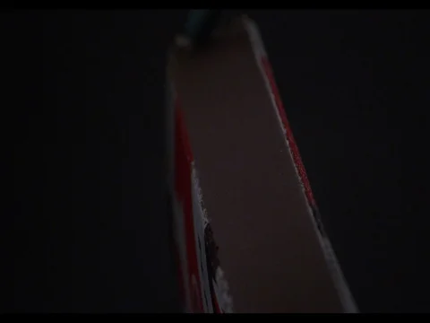 Match striking on the matchbox, on a black background, close-up, slow motion Stock Footage