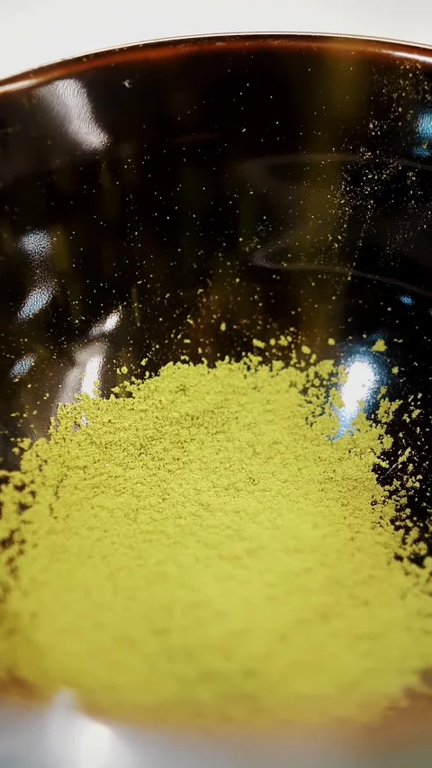 Matcha. close-up. sifted green matcha tea powder in a small black bowl. Making Stock Footage 323514692