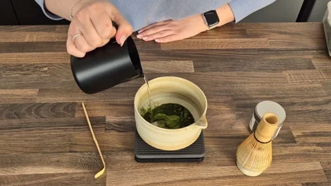 Matcha coffee making process . Adding espresso coffee to green matcha powder  Stock Footage 304740936