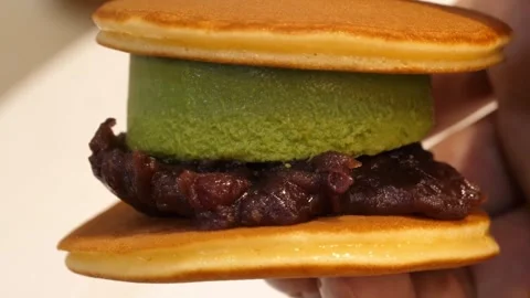 Matcha Green Tea and Red Bean Paste Dorayaki Pancake Sandwich Close Up Stock Footage 345292553