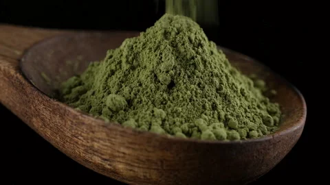 Matcha green tea powder sprinkle in wooden spoon Stock Footage 267680352