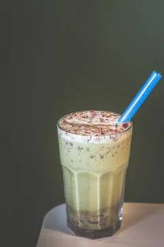 Matcha green tea red bean latte blended with ice and served in a tall glass Stock Photos