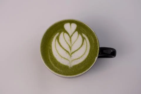 Matcha Latte Art In a ceramic cup. Black ceramic mug with hot Matcha latte... Фото