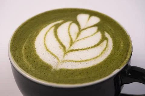 Matcha Latte Art In a ceramic cup. Black ceramic mug with hot Matcha latte... Stock Photos
