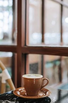 Matcha Latte on a black marble table near the window Stock Photos