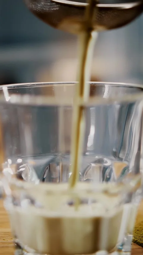 Matcha latte. close-up. barista is filtering mix drink of milk and matcha green Stock Footage 323515467