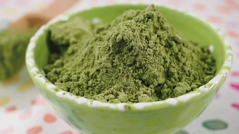 Matcha powder preparation in a kitchen setting Stock Footage 340122906