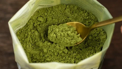 Matcha powder scooping with scoop from pack, closeup Stock Footage 335354466
