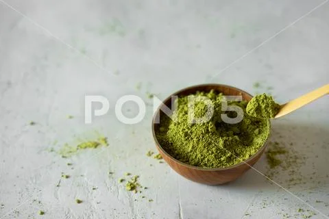 Matcha tea in a brown cup on a gray background Stock Photos