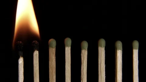 The matches are lit one from the other. Matches ignite on an isolated black back Stock Footage 274709359