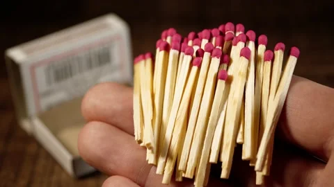 Matches are lying on the hand close-up. In the background is a blurry box of Stock Footage 229185175