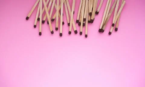 The matches lie in the upper part of the frame on a pink background. There is a Stock Photos