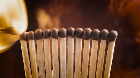 Matches light up one by another in series. Slow motion footage Stock Footage 104344169