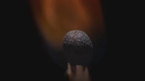 Matchstick with fire on the tip. Matchstick fires on Matchbox in macro slowmo Vídeo Stock 168065516