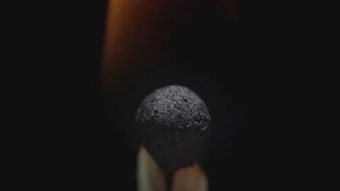 Matchstick with fire on the tip. Matchstick fires on Matchbox in macro slowmo Vídeo Stock 168454406