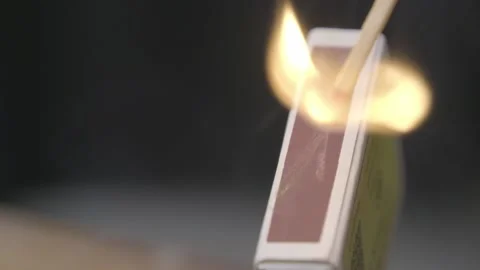 Matchstick fires on matchbox in slow motion close-up. Stock Footage 220050454
