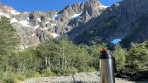 Mate and thermos with a mountain backdrop, El Bolson, Argentina Stock Footage 310610880