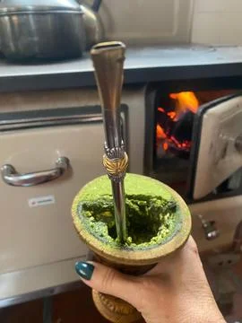Mate tea in a gourd by the fire. Stock Photos