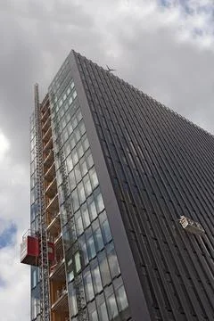Material hoist and working platform on the facade of a high-rise building Stock Photos