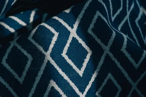 Material textile background. Blue fabric in diamonds. Close-up of the white b Stock Photos