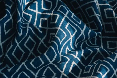 Material textile background. Blue fabric in diamonds. Close-up of the white b Stock Photos