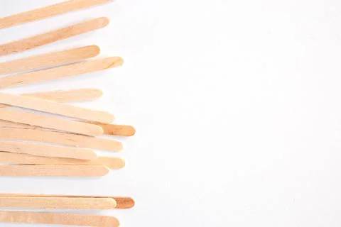 Materials for depilation of eyebrows and delicate areas. Wooden sticks lie Stock Photos