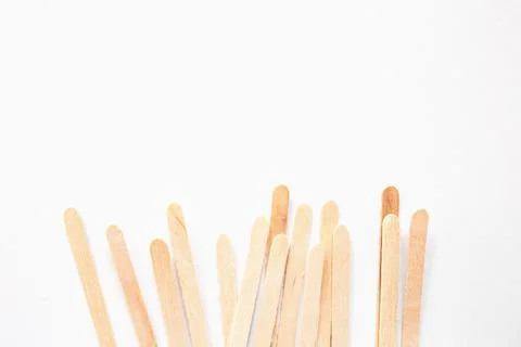 Materials for depilation of eyebrows and delicate areas. Wooden sticks lie on Stock Photos
