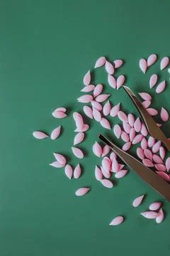 Materials for depilation of eyebrows and delicate areas. Pink wax granules on Foto stock